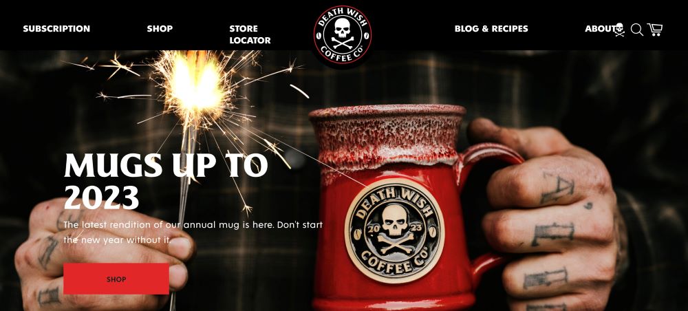 Death Wish Coffee background image featuring a mug with their logo and a sparkler